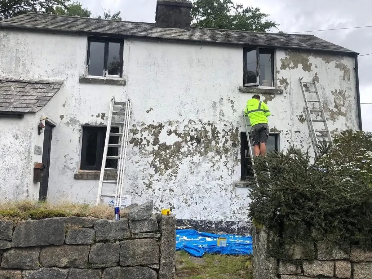 Cottage with blown, flaking render before repair in Newton Abbot
